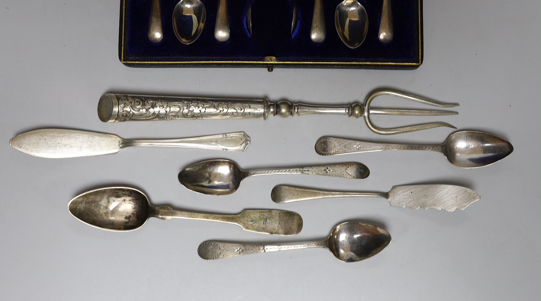 A cased set of six George V silver teaspoons, with sugar tongs and seven other items of silver or white metal flatware.